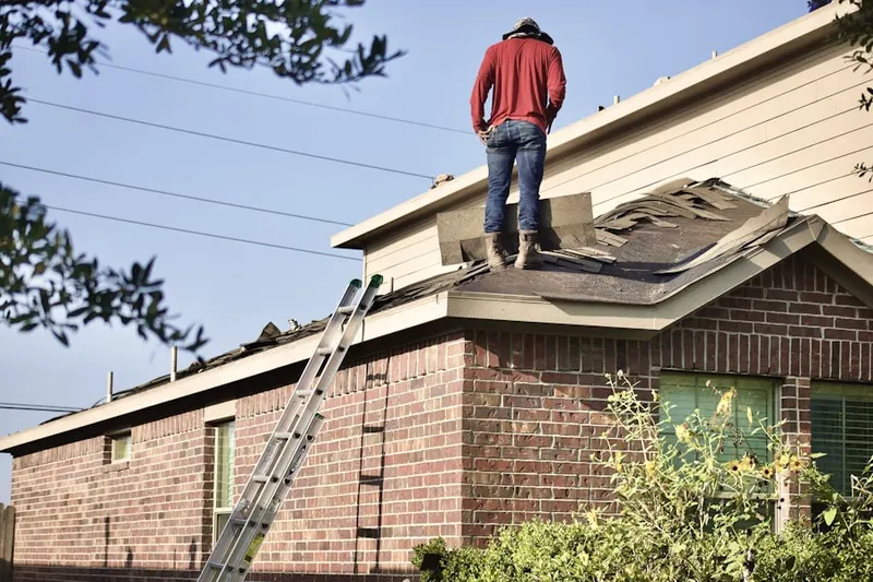 Professional roofer working on a residential roof in Woods Hole